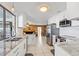 Bright kitchen features white cabinets, marble countertops, and stainless steel appliances at 288 Hernando Rd, Winter Haven, FL 33884