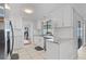 Bright kitchen features white cabinets, marble countertops, and stainless steel appliances at 288 Hernando Rd, Winter Haven, FL 33884