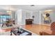Spacious living room featuring hardwood floors, a dining area, and a view of the backyard at 288 Hernando Rd, Winter Haven, FL 33884