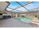 Relaxing screened-in pool and patio area with lake view, complete with outdoor seating at 288 Hernando Rd, Winter Haven, FL 33884