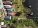 Aerial view of a home with expansive backyard, dock, boat house, and lake access at 4027 Island Lakes Dr, Winter Haven, FL 33881