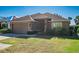 Charming single-Gathering home featuring a well-manicured lawn, two-car garage, and a neutral-toned exterior at 4027 Island Lakes Dr, Winter Haven, FL 33881