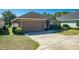 Charming single-story house featuring a spacious driveway, a two-car garage, and well-kept landscaping at 4027 Island Lakes Dr, Winter Haven, FL 33881