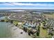 Aerial view of community clubhouse, pool, tennis courts, and lake at 4092 Carteret Dr, Winter Haven, FL 33884