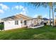 House with fenced backyard, screened patio, and lush lawn at 4092 Carteret Dr, Winter Haven, FL 33884