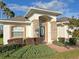 Front entrance of a charming home with stone accents and well-manicured landscaping at 4092 Carteret Dr, Winter Haven, FL 33884