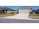 Gray house with a two-car garage and driveway, surrounded by a well-manicured lawn at 4364 Reding Way, Lakeland, FL 33813