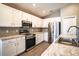 Modern kitchen with white cabinets, stainless steel appliances, and granite countertops at 4364 Reding Way, Lakeland, FL 33813
