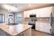 Modern kitchen with island, white cabinets, stainless steel appliances, and granite countertops at 4364 Reding Way, Lakeland, FL 33813