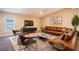 Spacious living room with leather sectional sofa and large TV at 4364 Reding Way, Lakeland, FL 33813