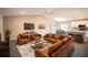 Open concept living room and kitchen with leather furniture at 4364 Reding Way, Lakeland, FL 33813