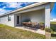 Covered patio with a wooden table and chairs at 4364 Reding Way, Lakeland, FL 33813
