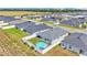 Aerial view of similar houses in a neighborhood with a fenced-in backyard and a pool at 566 Valentina Ln, Auburndale, FL 33823