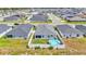 Aerial view of a fenced-in backyard with a pool in a neighborhood with similar houses at 566 Valentina Ln, Auburndale, FL 33823