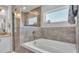 Serene bathroom featuring a large soaking tub, a glass-enclosed shower, and modern fixtures at 566 Valentina Ln, Auburndale, FL 33823