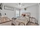 Cozy bedroom featuring a decorative bed frame, ceiling fan, and rustic-style nightstand at 566 Valentina Ln, Auburndale, FL 33823