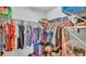 Organized walk-in closet with ample hanging space and shelving for efficient storage of clothes and accessories at 566 Valentina Ln, Auburndale, FL 33823