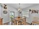 Inviting dining room with a wooden table, seating for six, and sliding glass doors to the outdoor area at 566 Valentina Ln, Auburndale, FL 33823
