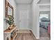Welcoming entryway with wood floors, decorative table, and a glimpse into the bedroom at 566 Valentina Ln, Auburndale, FL 33823