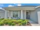 Inviting front porch with rocking chairs and manicured landscaping, creating a cozy curb appeal at 566 Valentina Ln, Auburndale, FL 33823