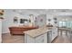 Open-concept kitchen with granite countertops, stainless appliances and a dining space beyond the island at 566 Valentina Ln, Auburndale, FL 33823