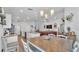Open-concept kitchen and dining area with modern fixtures, granite countertops, and seamless flow to the living room at 566 Valentina Ln, Auburndale, FL 33823