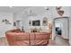 Spacious living room with a brown sectional couch, modern decor, and views into a home office at 566 Valentina Ln, Auburndale, FL 33823