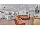 Open-concept living room featuring an attached kitchen, a comfortable sectional, and modern flooring at 566 Valentina Ln, Auburndale, FL 33823