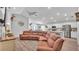 Open-concept living room flowing into the kitchen with a large sectional sofa and modern finishes at 566 Valentina Ln, Auburndale, FL 33823
