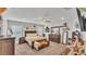 Spacious main bedroom with plush carpeting, fan, and a coordinating furniture set with a bench at 566 Valentina Ln, Auburndale, FL 33823