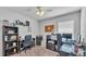 Bright office featuring two work areas, shelving, and contemporary decor at 566 Valentina Ln, Auburndale, FL 33823