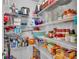 Well-organized pantry with wire shelving stocked with food, kitchen supplies, and household items at 566 Valentina Ln, Auburndale, FL 33823