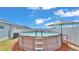 A delightful above-ground pool, complete with an umbrella and ladder, is the perfect way to cool off in the backyard at 566 Valentina Ln, Auburndale, FL 33823