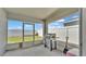 Enclosed outdoor patio with grill, looking out to fenced yard with a lawn mower at 566 Valentina Ln, Auburndale, FL 33823
