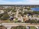 Expansive aerial view of a residential neighborhood featuring well-maintained homes and tree-lined streets near a lake at 5808 Driftwood Dr, Winter Haven, FL 33884