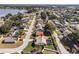 Beautiful aerial shot of a neighborhood showcasing lovely homes, lush trees, and well-kept lawns near a tranquil lake at 5808 Driftwood Dr, Winter Haven, FL 33884