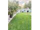 A well maintained lawn surrounded by tropical landscaping and privacy fence create a tranquil backyard oasis at 5808 Driftwood Dr, Winter Haven, FL 33884