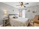 Comfortable bedroom features a queen-sized bed, tile floors, and a ceiling fan with light fixture at 5808 Driftwood Dr, Winter Haven, FL 33884