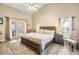 Serene main bedroom with a king-sized bed, neutral decor, and access to the lanai at 5808 Driftwood Dr, Winter Haven, FL 33884