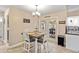 Cozy dining area with a table and seating for four, adjacent to the kitchen at 5808 Driftwood Dr, Winter Haven, FL 33884