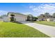 Charming single-story home boasts a well-maintained lawn and a long driveway, perfect for multiple vehicles at 5808 Driftwood Dr, Winter Haven, FL 33884