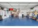 Two-car garage with overhead storage and epoxy floor at 5808 Driftwood Dr, Winter Haven, FL 33884