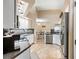 Well-equipped kitchen with stainless steel appliances, white cabinets, and an eat-in dining area at 5808 Driftwood Dr, Winter Haven, FL 33884