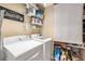 Laundry room features modern washing machine and dryer with shelving for storage of supplies at 5808 Driftwood Dr, Winter Haven, FL 33884