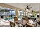 Enclosed patio with outdoor furniture, ceiling fans, barbecue grill, and view of the pool at 5808 Driftwood Dr, Winter Haven, FL 33884