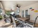 Covered patio with dining table, ceiling fans, and comfortable seating for outdoor gatherings at 5808 Driftwood Dr, Winter Haven, FL 33884
