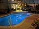 Inviting freeform pool with blue lighting for nighttime enjoyment at 5808 Driftwood Dr, Winter Haven, FL 33884