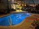 Inviting kidney-shaped pool and rock waterfall feature are ready for day or nighttime relaxation at 5808 Driftwood Dr, Winter Haven, FL 33884