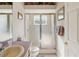 Bathroom featuring a glass-enclosed shower, toilet, and sink with a large mirror above it at 6683 Highlands Creek Blvd, Lakeland, FL 33813