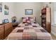 Bedroom featuring a bed with a decorative quilt, a bookshelf, and a cozy reading chair at 6683 Highlands Creek Blvd, Lakeland, FL 33813